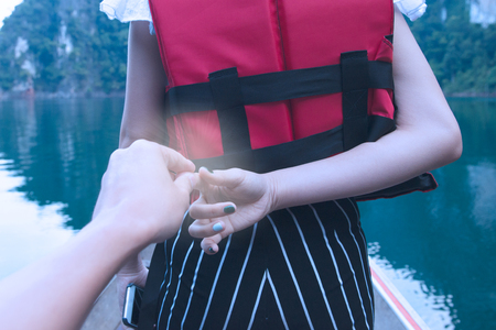 Valentine Day concept, Male and female hand holding each other with beautiful viewの写真素材