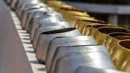 A row of bat monk, white and yellow,silver and goldの写真素材