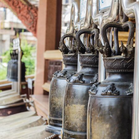 Many black bell outside the temple in Thailandの写真素材