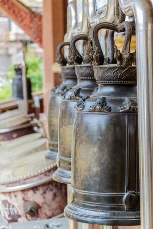 Many black bell outside the temple in Thailandの写真素材