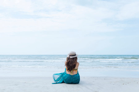 Lifestyle Woman Sitting On The Beachの写真素材