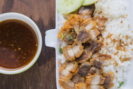 Freshly baked crispy pork eating with rice and red sauce.の写真素材