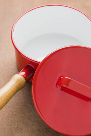 Red cooking pot vintage kitchen utensils on a wooden background.の写真素材