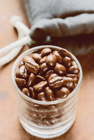 Coffee beans for espresso shot in a cafe or coffee shop. Photo in vintage color tone style.の写真素材