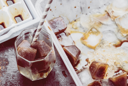 Iced coffee homemade making from ice cubes coffee frozen served in a glass. Photo in vintage color tone style.の写真素材