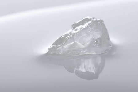 Ice melting into water, Like global warming every day.の写真素材