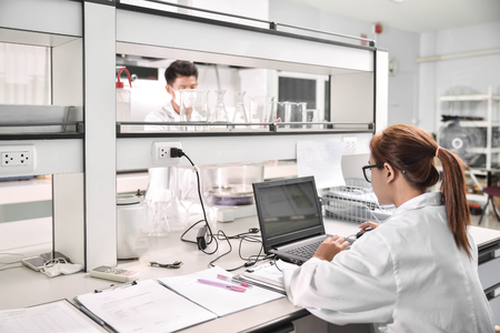 Young laboratory assistant prepare instrument for chemical lab experiment in Labの写真素材