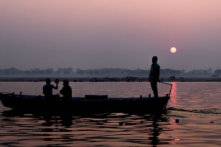 Silhoutte Old Fisherman boat at sunrise vintage filterの写真素材