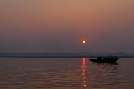 Silhoutte Old Fisherman boat at sunriseの写真素材