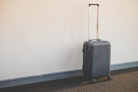 stack of traveling luggage in airport terminal building and passenger with white background for your text vintage filterの写真素材