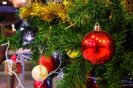 Christmas ball ornaments decoration hanging on fir tree over red circle bokeh blurred night light background with copy space for text, greeting card happy new year 2017の写真素材