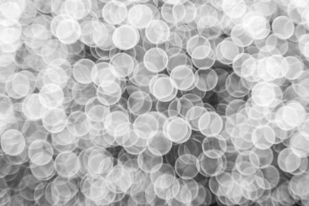 silver Sparkling Lights Festive background with texture. Abstract Christmas twinkled bright bokeh defocused and Falling stars. Winter Card or invitation.の写真素材