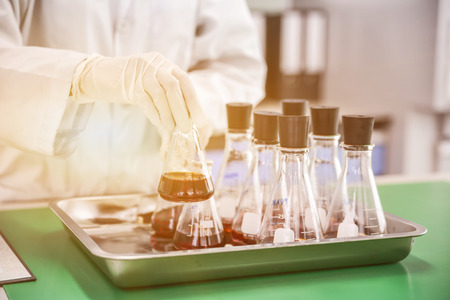 scientist are experimenting with red chemicalsの写真素材
