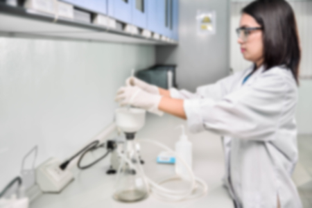 Young laboratory assistant prepare instrument for chemical lab experiment in Labの写真素材