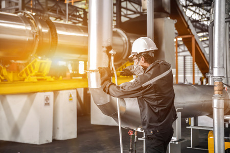 Engineers working in temperature control room of large buildingの写真素材