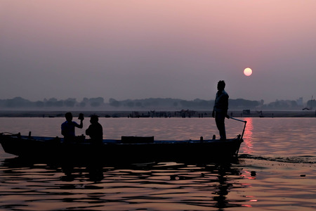 Silhoutte Old Fisherman boat at sunrise vintage filterの写真素材