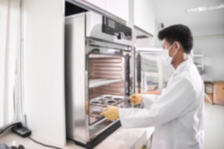 Young laboratory assistant prepare instrument for chemical lab experiment in Lab