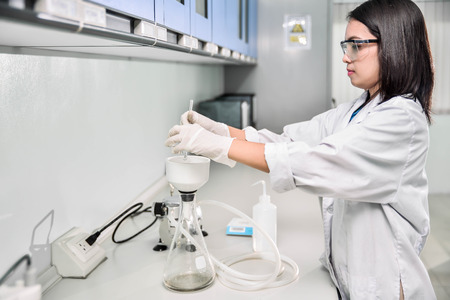 Young laboratory assistant prepare instrument for chemical lab experiment in Labの写真素材