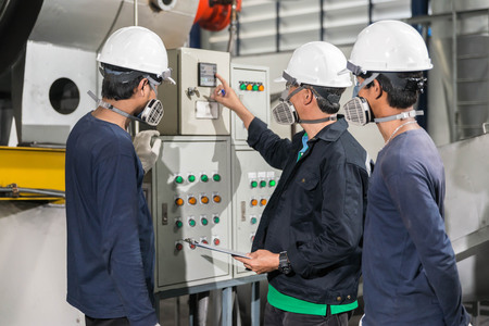 Engineers in mechanical factory reading instructionsの写真素材