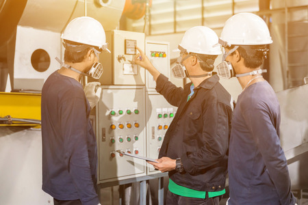Engineers in mechanical factory reading instructionsの写真素材