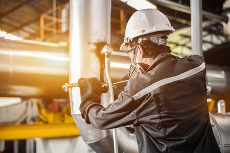 Engineers working in temperature control room of large buildingの写真素材