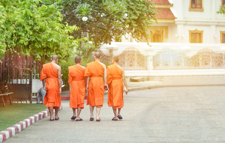 four Monks walking on ancient temple Thailandの写真素材
