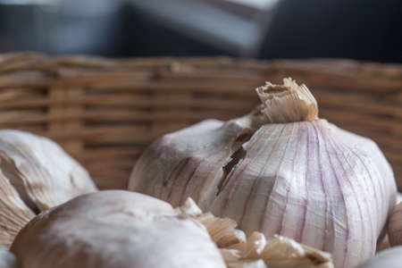 Whole heads of garlic in a wooden basket.