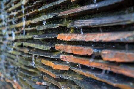 Close-up detail of a natural slate ledge waterfall wall. Home and interior design concept.の写真素材