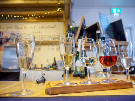 Wide closeup of multiple glasses of fine wines during a tasting session. Penzace, Cornwall, England....