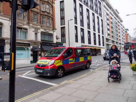 LONDON, ENGLAND - MARCH 8, 2019: Wide angle view of Parliamentary and Diplomatic Protection Group police van patrolling the streets of Knightsbridge. Terrorism and law enforcement.のeditorial素材