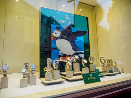 BATH, UNITED KINGDOM - MARCH 5, 2019: Wide angle view of the Rolex plaque next to multiple gold...