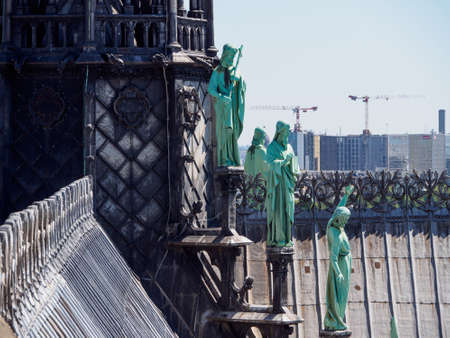 PARIS, FRANCE - MAY 7, 2018: Wide closeup of copper statues of the 12 Apostles of Jesus along the gothic spires of Notre-Dame Cathedral. Travel and historical architecture.のeditorial素材