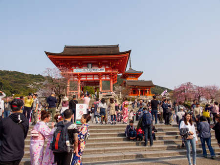 KYOTO, JAPAN - MARCH 29, 2018: Wide view of crowds of tourists on the steps leading to the Niomon Deva Gate on a sunny afternoon. Kiyomizu-Dera, Higashiyama. Travel and tourism.のeditorial素材