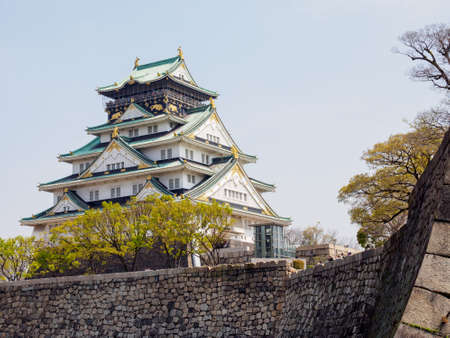 OSAKA, JAPAN - APRIL 3, 2018: Wide view of the Osaka castle Tenshu tower and Moat walls on a clear, sunny, day. Travel and Hanami cherry blossom season.のeditorial素材