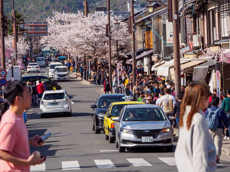 KYOTO, JAPAN - MARCH 30, 2018: Wide angle view of tourists packed onto the crowded and streets along downtown Arashiyama, Ukyo-Ku. Travel and tourism.のeditorial素材
