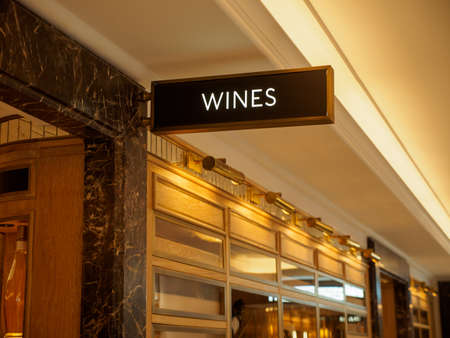 LONDON, UNITED KINGDOM - MARCH 7, 2019: Closeup of a sign at the entrance to the wine cellar of the famous Harrods department store. Travel and luxury shopping.のeditorial素材