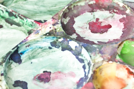 wooden art palette with paint and brushesの写真素材
