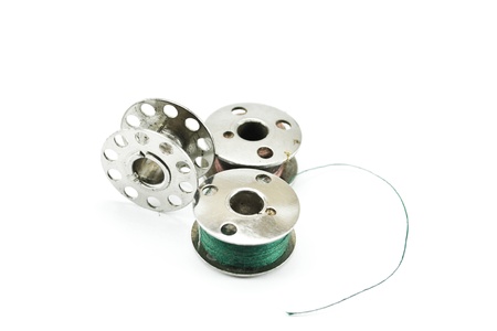 Metal spools of thread on white backgroundの写真素材
