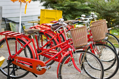 Red bicycle parked in cityの写真素材