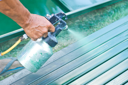 workers painted green for sheet metalの写真素材