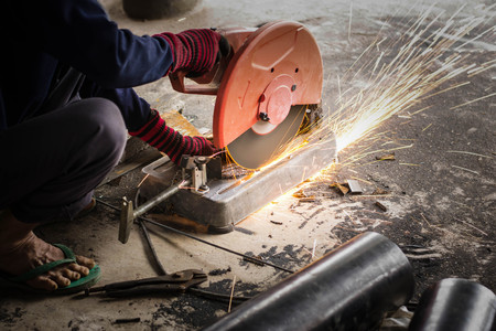 Workers use tools to cut steel in factoriesの写真素材