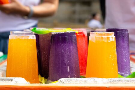 Colorful soft drink in plastic cup