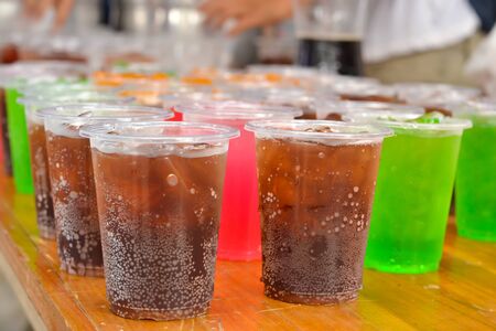 Colorful soft drink in plastic cupの写真素材