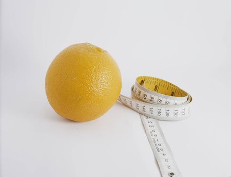 orange fruit isolated with tape measureの写真素材