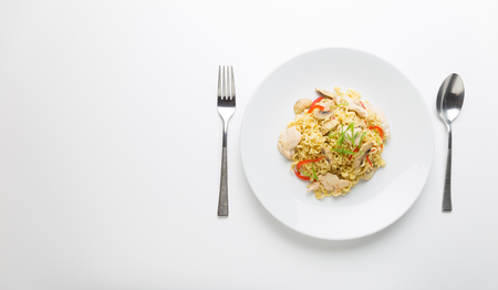 Stir-fry noodles with chicken meat, mushroom and red capsicum in a plate on white background copy spaceの写真素材