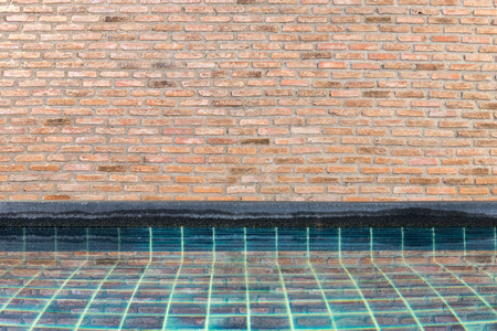 Brick wall and swimming poolの写真素材