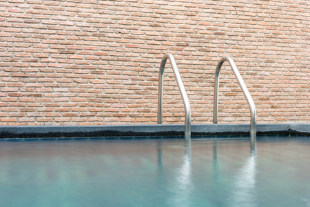 Swimming pool with stairnice brick wall backgroundの写真素材