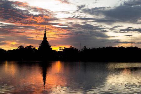 Silhouette thai temple in north east thailand sun set periodの写真素材