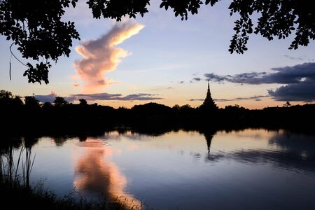 Silhouette thai temple in north east thailand sun set periodの写真素材
