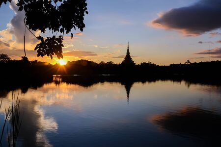 Silhouette thai temple in north east thailand sun set periodの写真素材